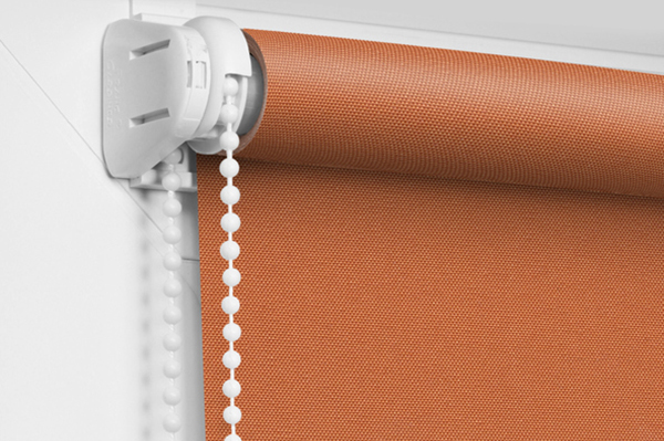 Color blackout roller blind on the white plastic window.